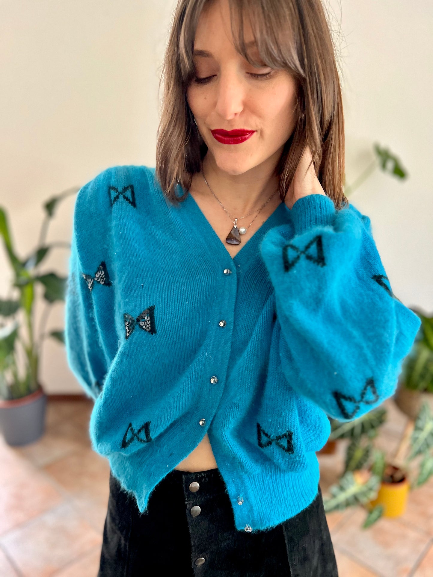 1960's vintage turquoise angora cardigan with black bow details