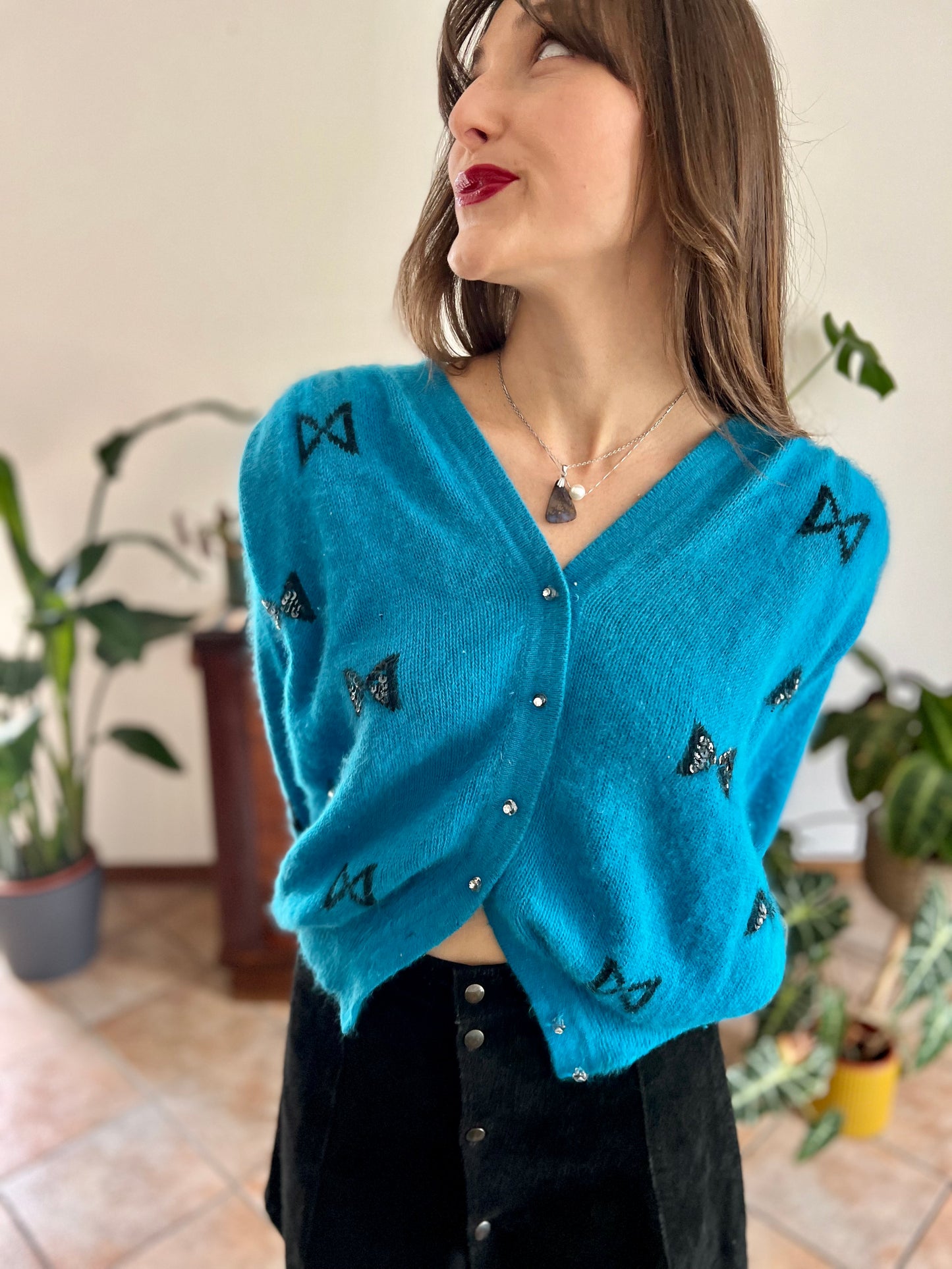 1960's vintage turquoise angora cardigan with black bow details