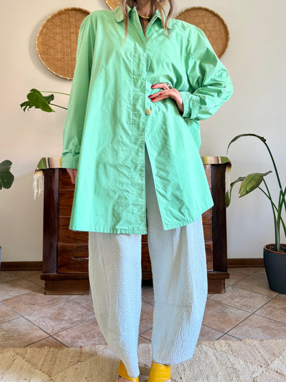 1999’s vintage green trench coat with blue and white polkadot lining