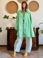 1999’s vintage green trench coat with blue and white polkadot lining