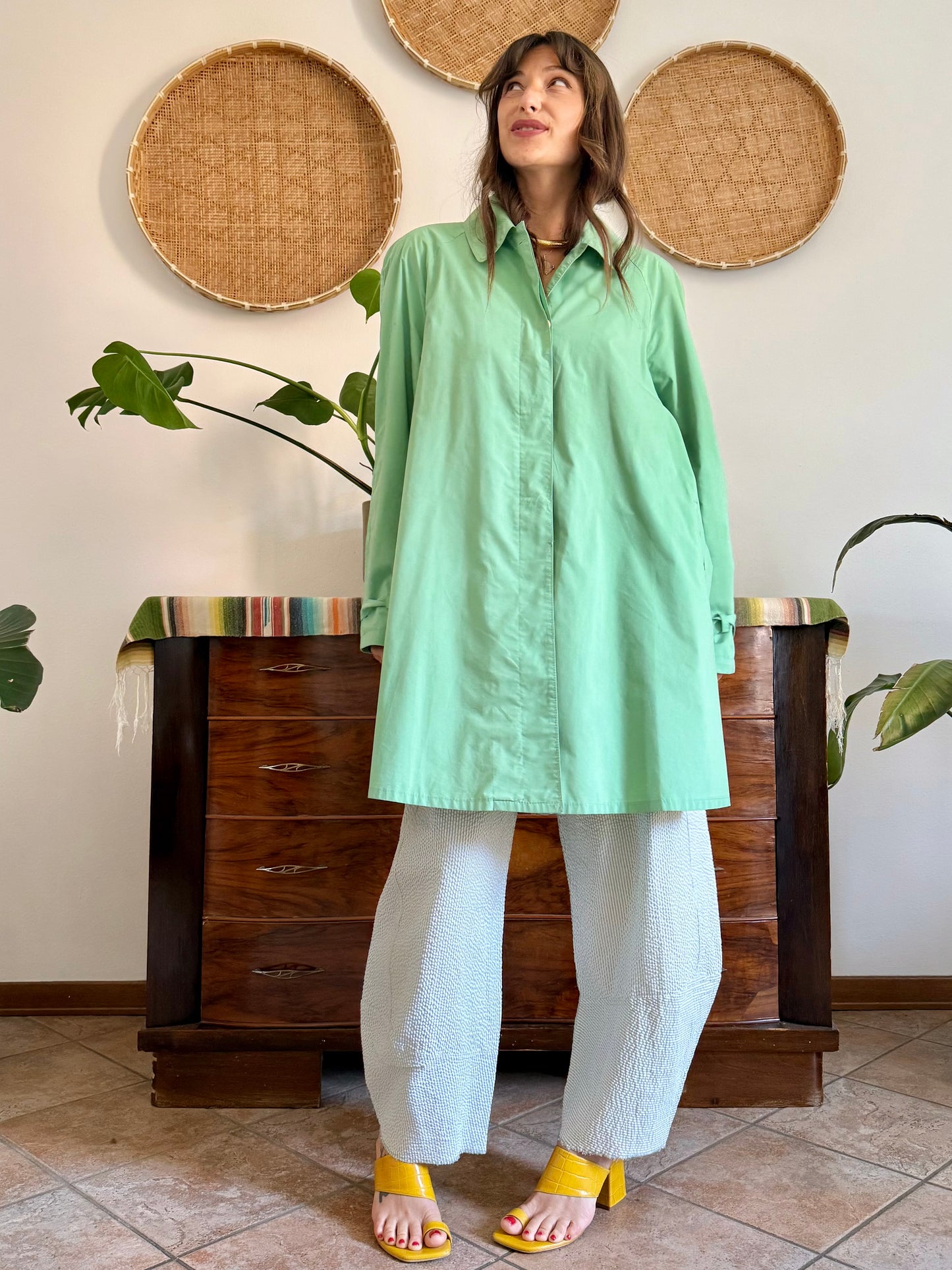 1999’s vintage green trench coat with blue and white polkadot lining