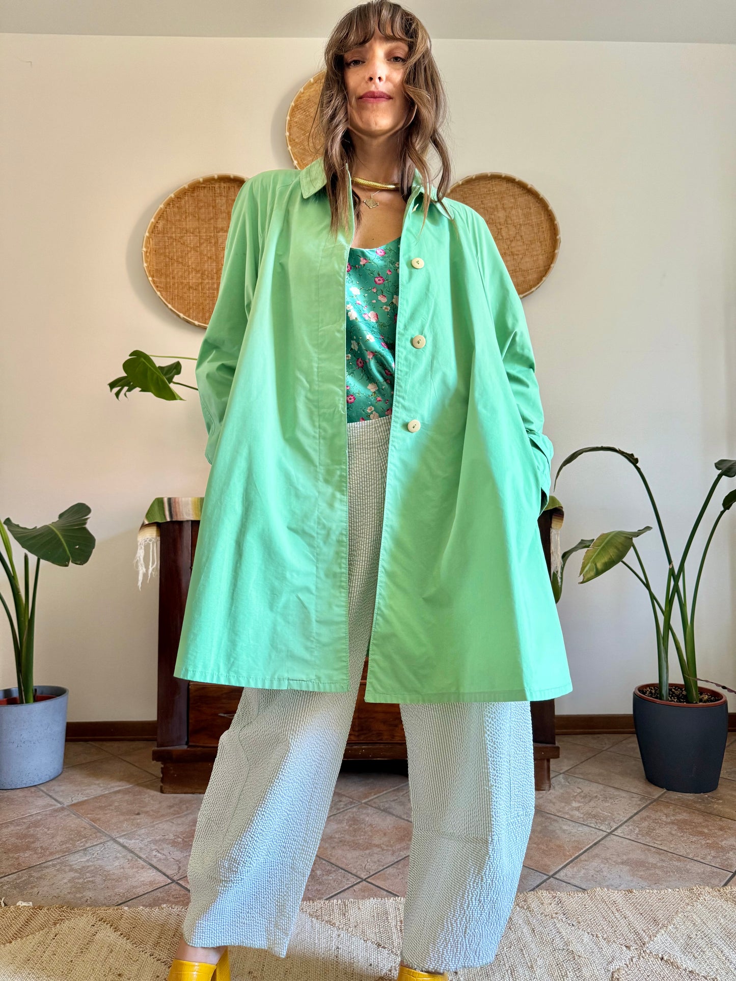 1999’s vintage green trench coat with blue and white polkadot lining