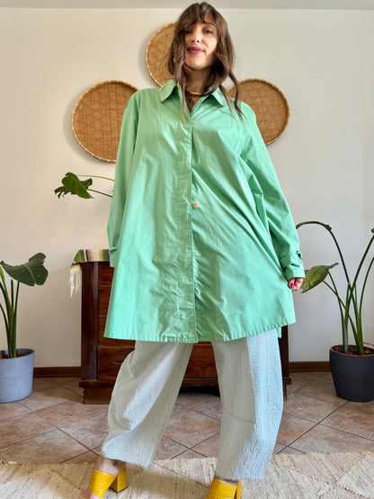 1999’s vintage green trench coat with blue and white polkadot lining