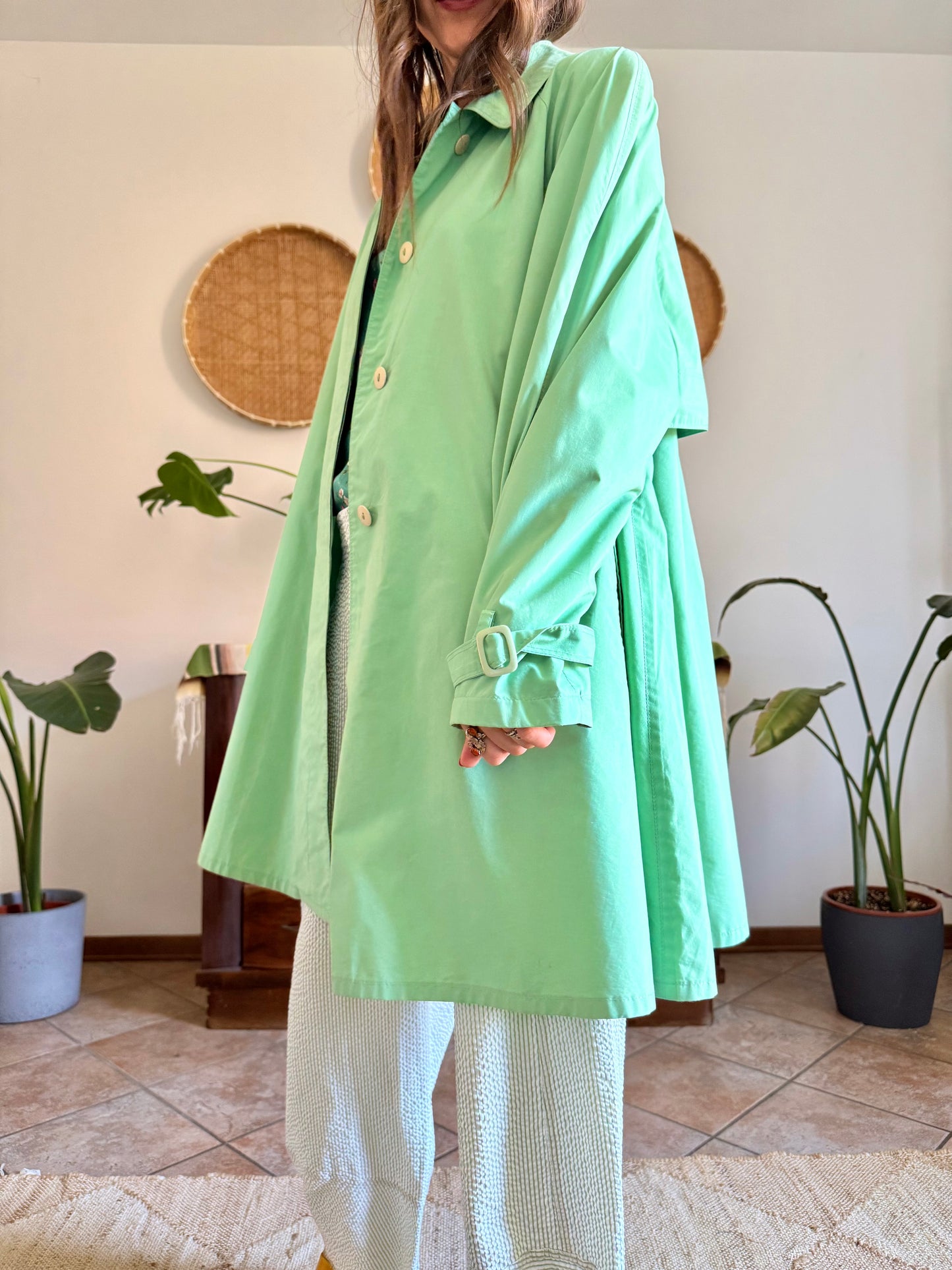 1999’s vintage green trench coat with blue and white polkadot lining
