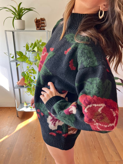 1970's vintage black hand knit pullover with burgundy and green floral pattern